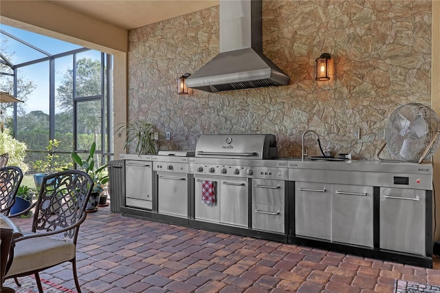 view of patio / terrace with sink, a lanai, and exterior kitchen