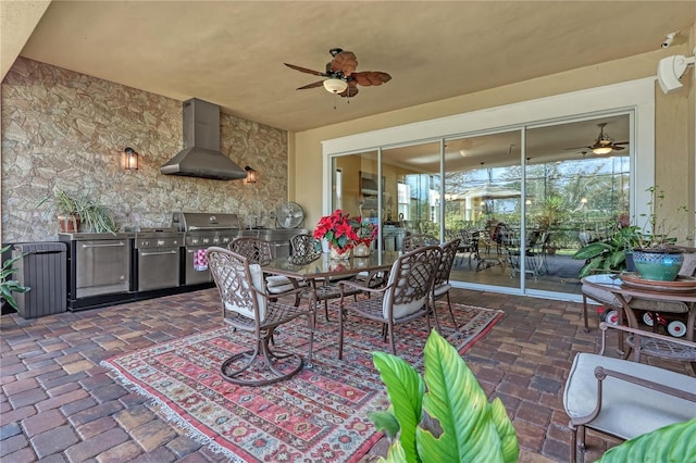 view of patio / terrace with ceiling fan, a grill, and exterior kitchen