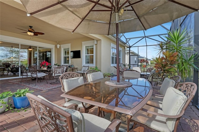 view of patio / terrace with ceiling fan and a lanai