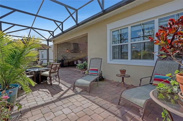 view of patio with a lanai and a shed