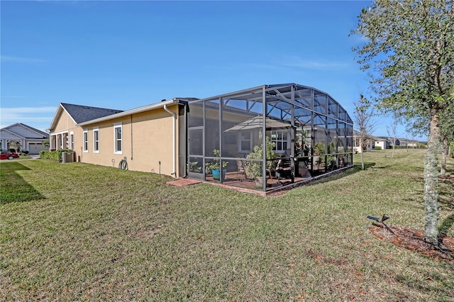 view of yard with central AC, a lanai, and a patio area