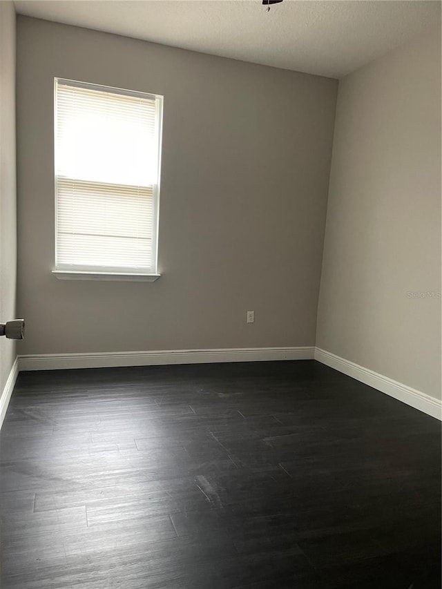 unfurnished room featuring dark hardwood / wood-style floors