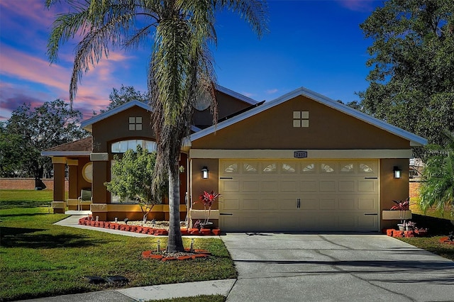 view of front of property featuring a lawn and a garage