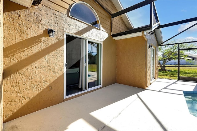 view of patio with glass enclosure