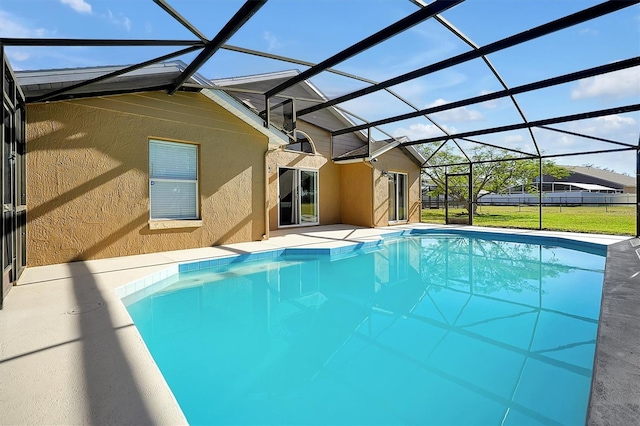 view of swimming pool featuring a lanai and a yard