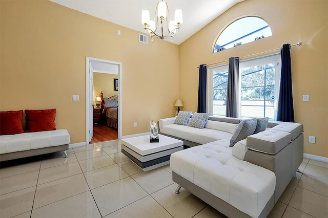 living room featuring light tile patterned flooring, vaulted ceiling, and an inviting chandelier