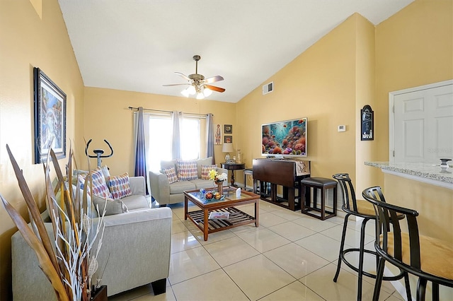 living room with ceiling fan, light tile patterned flooring, and lofted ceiling