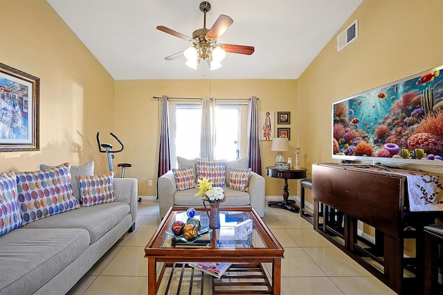 tiled living room featuring ceiling fan and vaulted ceiling