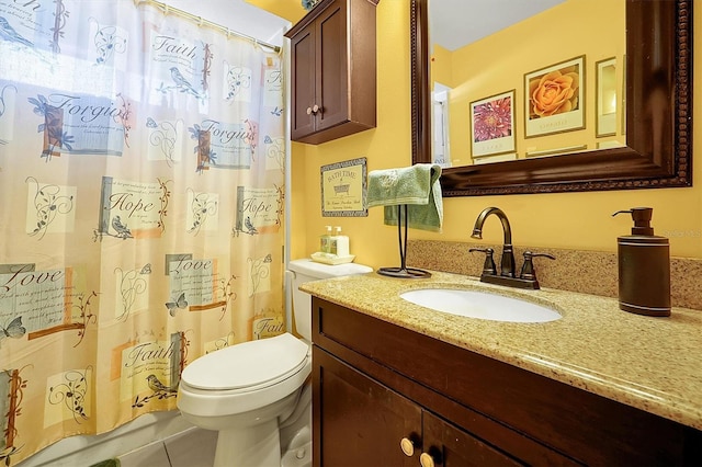 bathroom featuring tile patterned flooring, vanity, and toilet