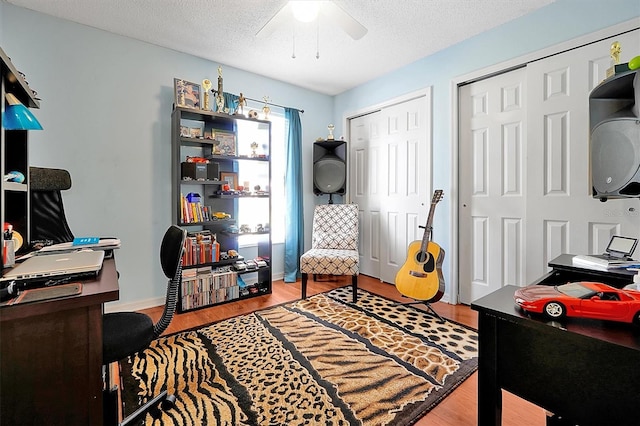 office area featuring a textured ceiling, hardwood / wood-style flooring, and ceiling fan