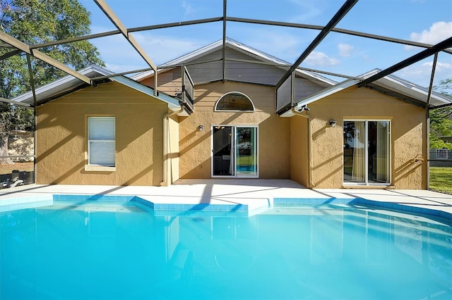 rear view of property featuring glass enclosure