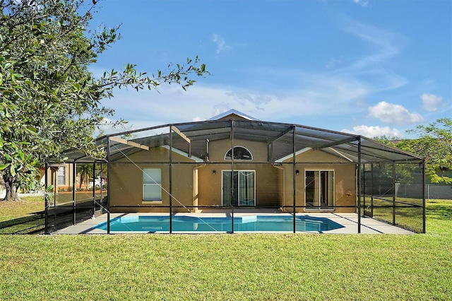 back of property with glass enclosure, a patio area, and a yard