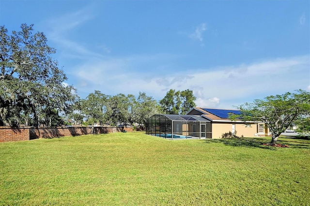 view of yard featuring a lanai and a fenced in pool