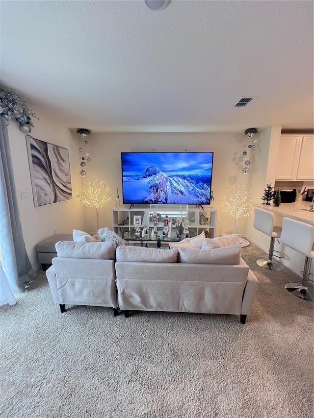 carpeted living room featuring a textured ceiling