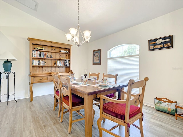 1281 N Timucuan Trl, Inverness, FL 34453 - dining area with vaulted ceiling, light hardwood / wood-style flooring, and a notable chandelier