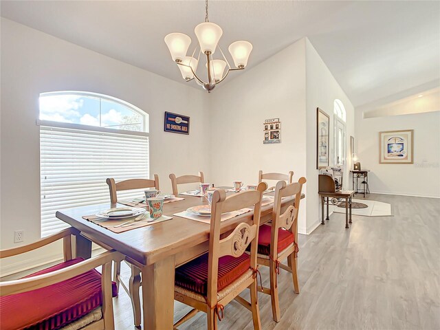 1281 N Timucuan Trl, Inverness, FL 34453 - dining room featuring light hardwood / wood-style flooring, a chandelier, and vaulted ceiling