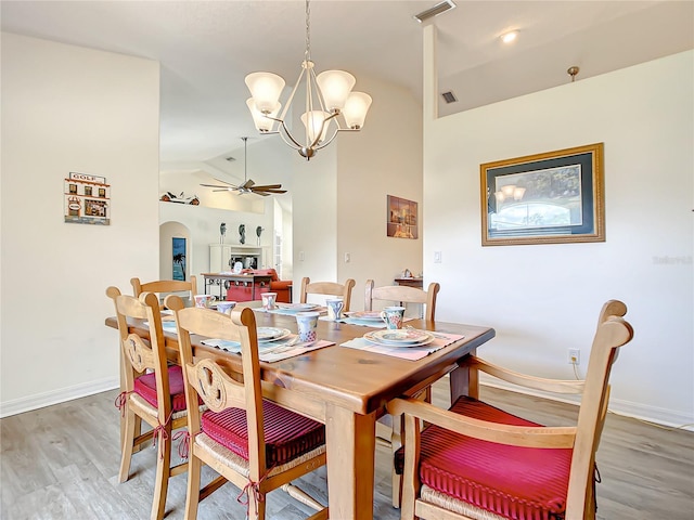 1281 N Timucuan Trl, Inverness, FL 34453 - dining space with ceiling fan with notable chandelier, hardwood / wood-style flooring, and lofted ceiling
