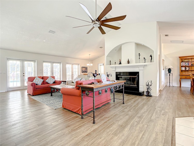 1281 N Timucuan Trl, Inverness, FL 34453 - living room with ceiling fan with notable chandelier, light wood-type flooring, lofted ceiling, and french doors