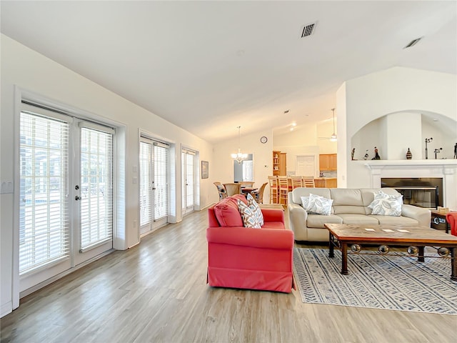 1281 N Timucuan Trl, Inverness, FL 34453 - living room with french doors, hardwood / wood-style floors, a chandelier, and lofted ceiling