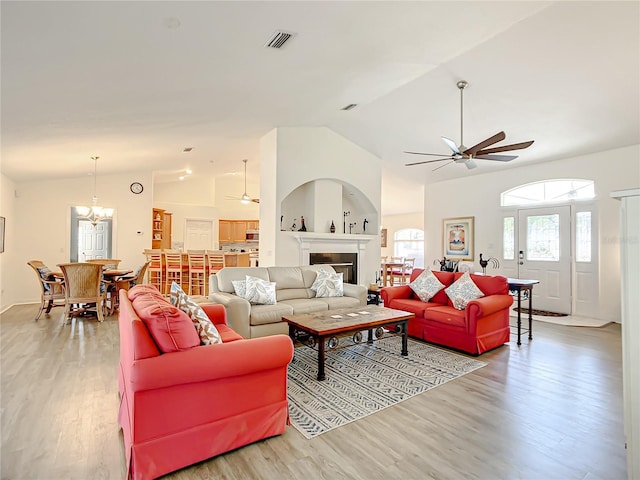 1281 N Timucuan Trl, Inverness, FL 34453 - living room with ceiling fan with notable chandelier, wood-type flooring, and high vaulted ceiling