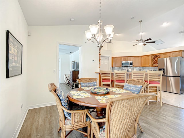 1281 N Timucuan Trl, Inverness, FL 34453 - dining area featuring ceiling fan with notable chandelier, light hardwood / wood-style floors, and vaulted ceiling