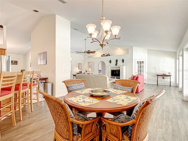 1281 N Timucuan Trl, Inverness, FL 34453 - dining space featuring ceiling fan with notable chandelier, light hardwood / wood-style floors, and vaulted ceiling