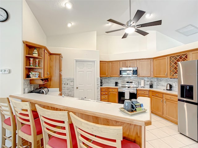 1281 N Timucuan Trl, Inverness, FL 34453 - kitchen with tasteful backsplash, kitchen peninsula, high vaulted ceiling, and appliances with stainless steel finishes