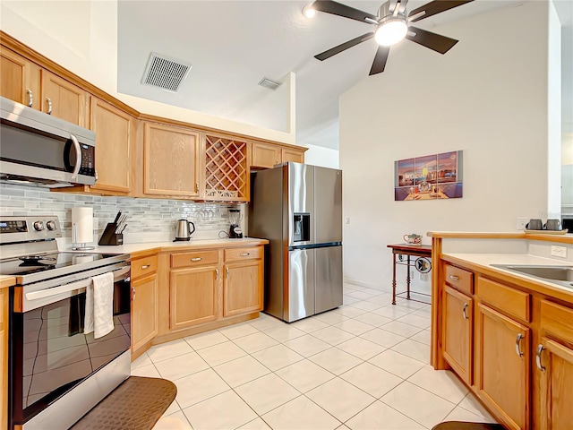 1281 N Timucuan Trl, Inverness, FL 34453 - kitchen with ceiling fan, high vaulted ceiling, backsplash, light tile patterned floors, and appliances with stainless steel finishes