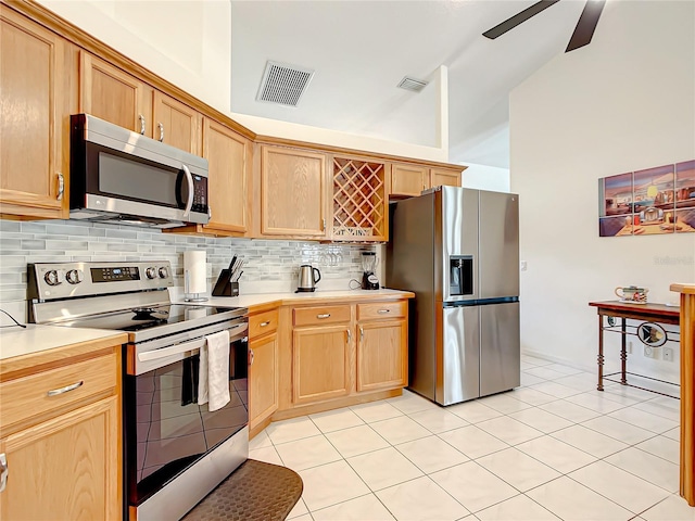 1281 N Timucuan Trl, Inverness, FL 34453 - kitchen with appliances with stainless steel finishes, vaulted ceiling, tasteful backsplash, and light tile patterned floors