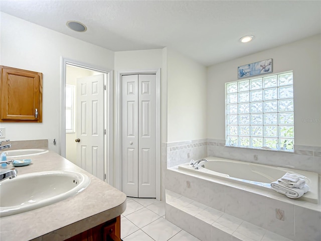1281 N Timucuan Trl, Inverness, FL 34453 - bathroom featuring tile patterned floors, vanity, and a relaxing tiled tub