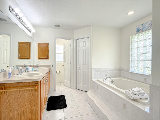 1281 N Timucuan Trl, Inverness, FL 34453 - bathroom featuring tile patterned flooring, vanity, and a relaxing tiled tub
