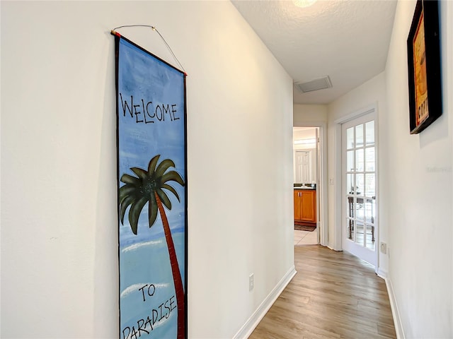 1281 N Timucuan Trl, Inverness, FL 34453 - corridor with light wood-type flooring and a textured ceiling