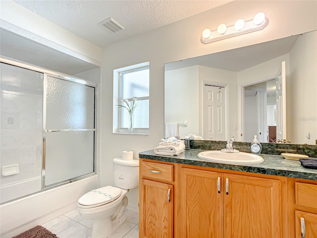 1281 N Timucuan Trl, Inverness, FL 34453 - full bathroom featuring vanity, tile patterned flooring, toilet, enclosed tub / shower combo, and a textured ceiling