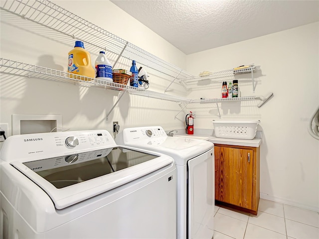 1281 N Timucuan Trl, Inverness, FL 34453 - clothes washing area featuring washer and clothes dryer, light tile patterned flooring, cabinets, and a textured ceiling