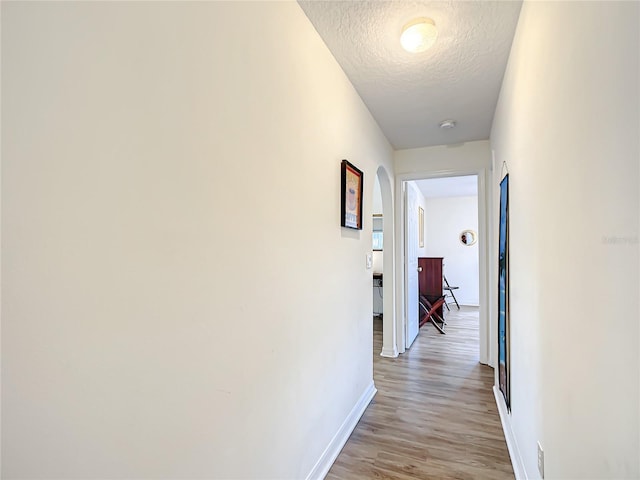 1281 N Timucuan Trl, Inverness, FL 34453 - hallway with light wood-type flooring and a textured ceiling