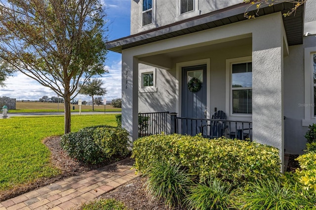 doorway to property with a yard