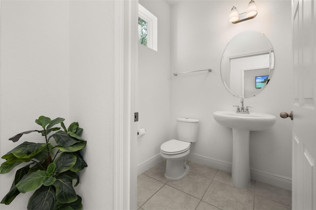 bathroom with tile patterned flooring, toilet, and sink