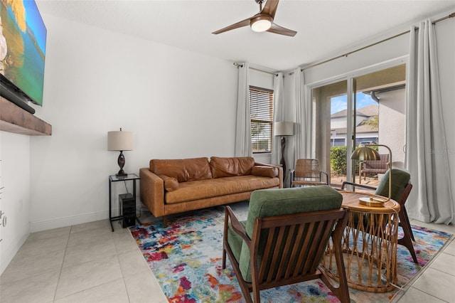 living room with ceiling fan and light tile patterned flooring