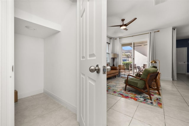 interior space featuring ceiling fan and tile patterned flooring