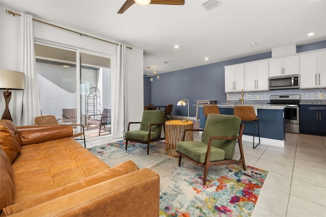 tiled living room featuring ceiling fan