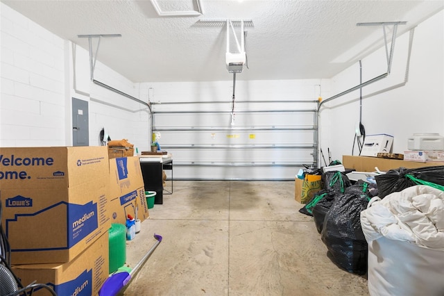 garage featuring a garage door opener and electric panel