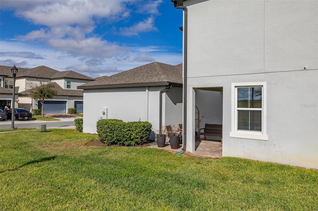 view of side of property with a yard