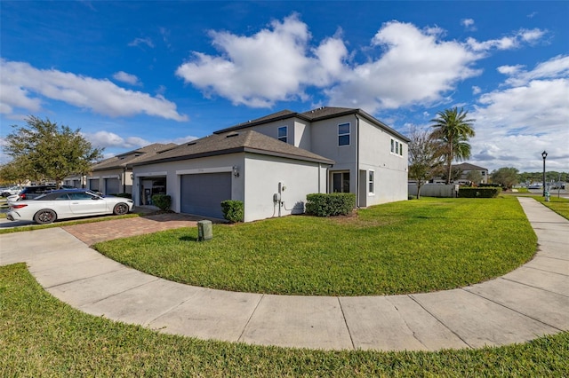 view of side of home featuring a garage and a yard