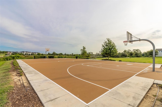 view of basketball court with a lawn