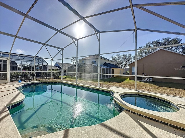 view of swimming pool featuring a lanai and an in ground hot tub