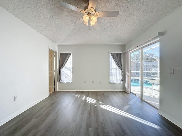 empty room featuring a textured ceiling, dark hardwood / wood-style floors, and ceiling fan