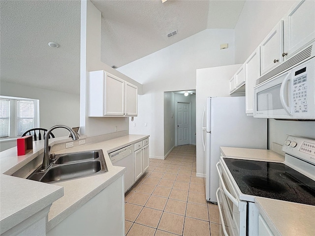 kitchen featuring white cabinetry, lofted ceiling, sink, and white appliances