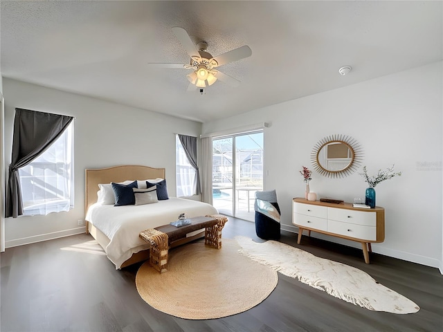 bedroom featuring ceiling fan, dark hardwood / wood-style floors, and access to exterior