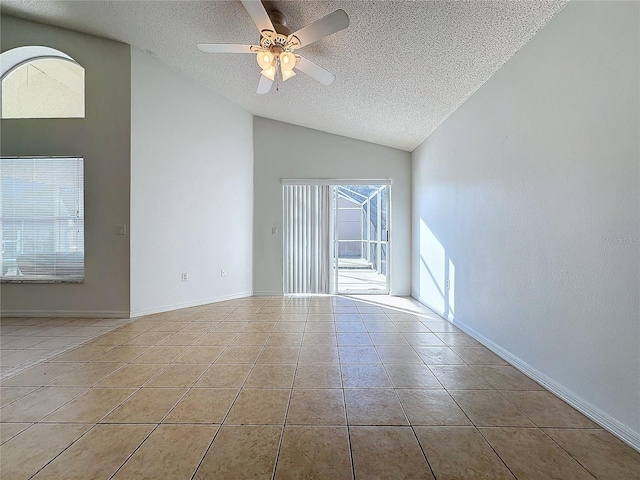 empty room featuring ceiling fan, light tile patterned flooring, a textured ceiling, and vaulted ceiling