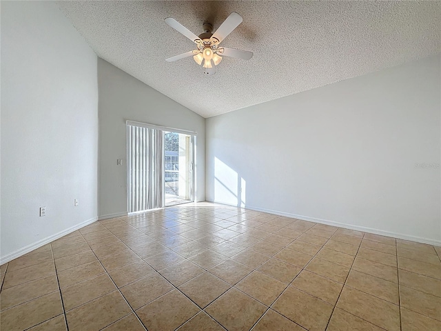 tiled empty room with ceiling fan, lofted ceiling, and a textured ceiling